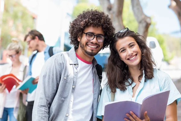 Portrait of students holding book — Stock Photo, Image
