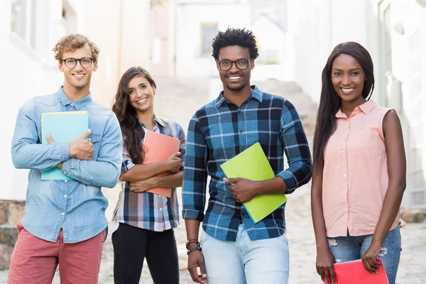 Portrait of friends holding book — Stock Photo, Image