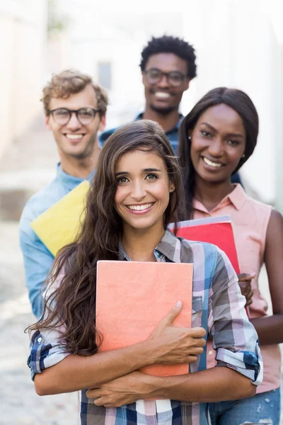 Portrait of friends holding book — Stock Photo, Image