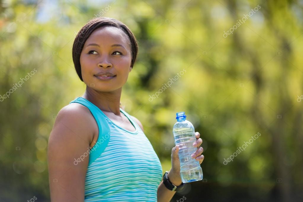 Woman holding water bottle Stock Photo by ©Wavebreakmedia 106534608