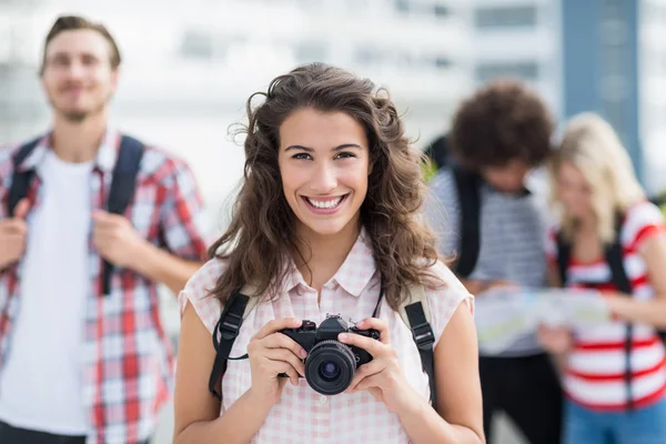 Portrait of young woman holding camera — Stock Photo, Image
