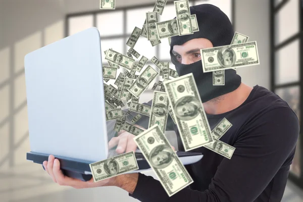 Burglar with balaclava holding laptop — Stock Photo, Image