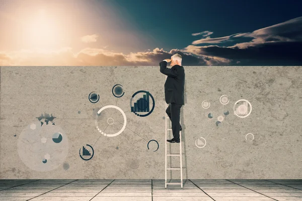 Mature businessman standing on ladder — Stock Photo, Image