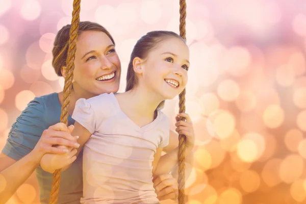 De swingende dochter moeder in park — Stockfoto