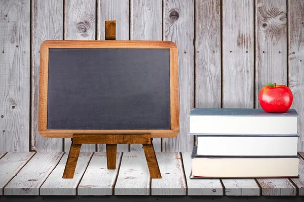 Blackboard against wooden planks — Stock Photo, Image