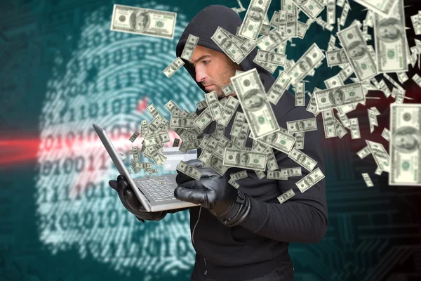 Hacker holding laptop and credit card — Stock Photo, Image