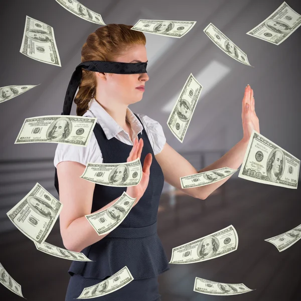 Businesswoman in blindfold with dollars in air — Stock Photo, Image