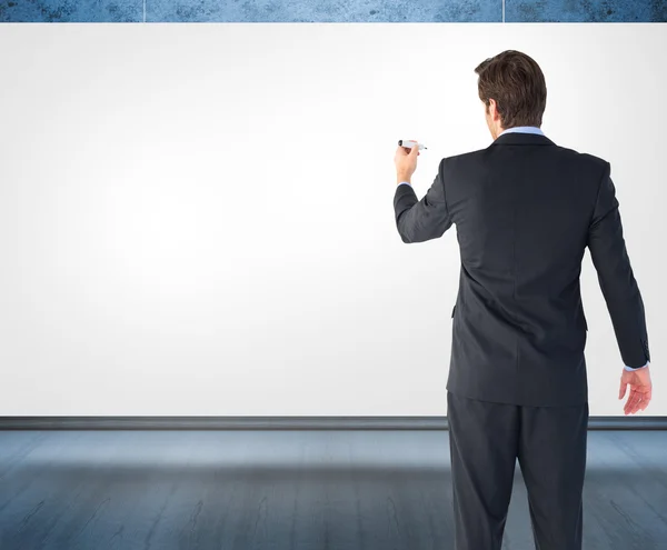Businessman standing and writing with marker — Stock Photo, Image