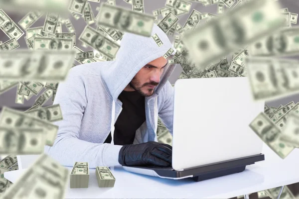 Serious burglar hacking into laptop — Stock Photo, Image