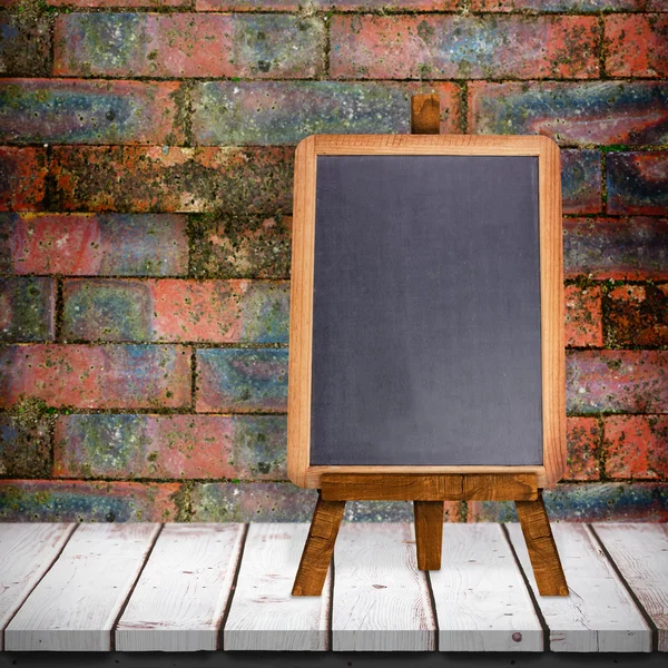 Blackboard against brick wall — Stock Photo, Image