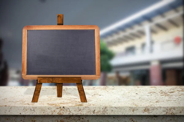 Shopping mall against blackboard — Stock Photo, Image