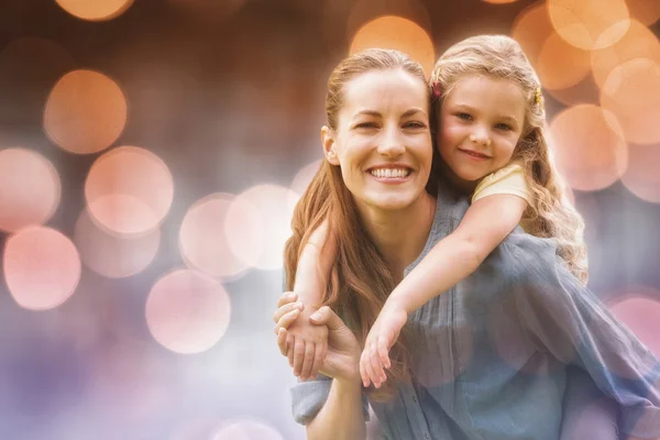 Woman carrying girl at park — Stock Photo, Image