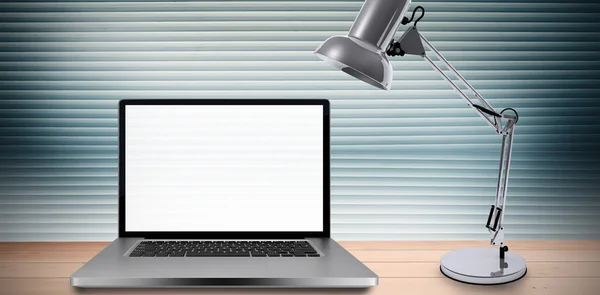 Skrivbord med laptop och ljus lampa — Stockfoto