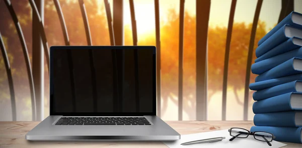 Desk with laptop and books — Stock Photo, Image