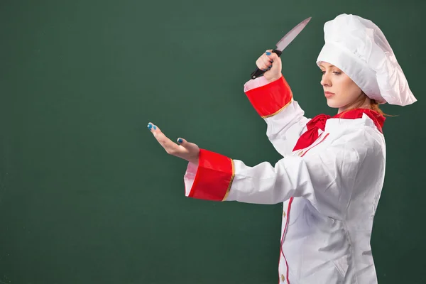 Pretty chef slicing with knife — Stock Photo, Image