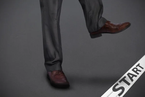 Composite image of businessman stepping — Stock Photo, Image