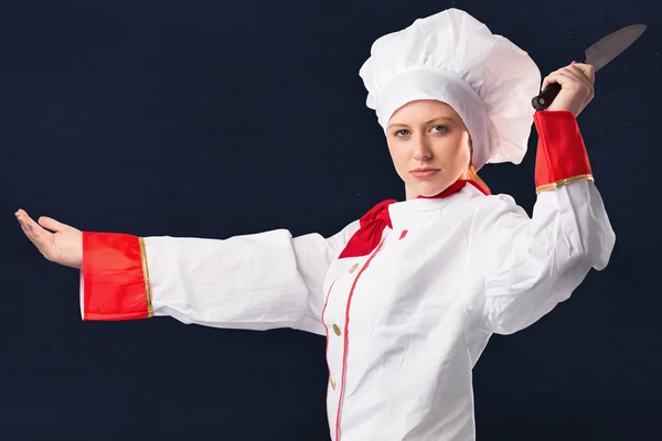 Pretty chef slicing with knife — Stock Photo, Image