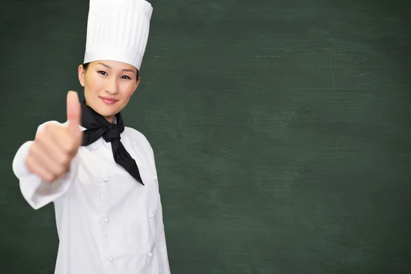 Cozinheira fêmea gesto polegares para cima — Fotografia de Stock