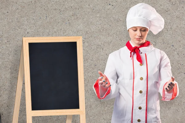 Pretty chef standing with hands out — Stock Photo, Image