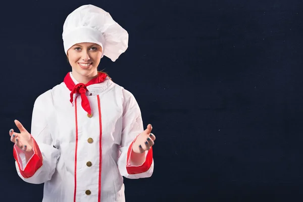 Pretty chef standing with hands out — Stock Photo, Image