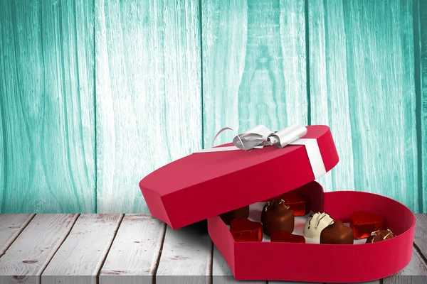 Composite image of heart shaped box of candy — Stock Photo, Image