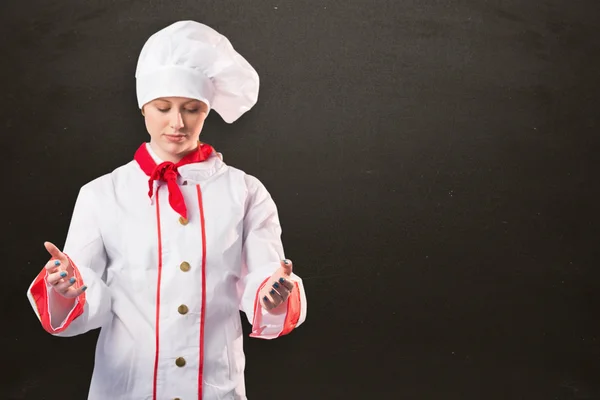 Pretty chef standing with hands out — Stock Photo, Image