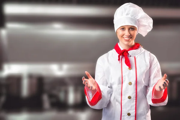 Pretty chef standing with hands out — Stock Photo, Image