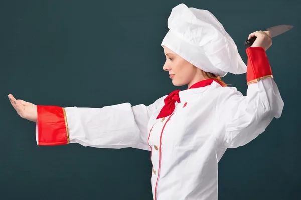 Pretty chef slicing with knife — Stock Photo, Image