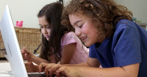 Hermano y hermana usando laptop y tablet en el suelo — Vídeos de Stock