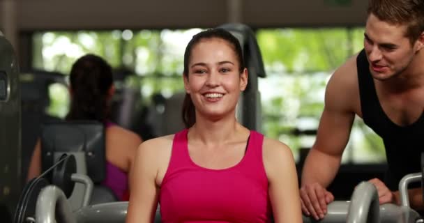 Fit woman using weight machine — Stock Video