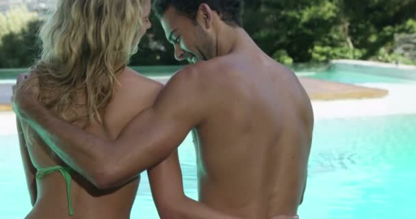 Linda pareja abrazándose en la piscina — Vídeo de stock