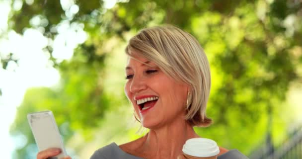 Smiling woman using smartphone — Stock Video