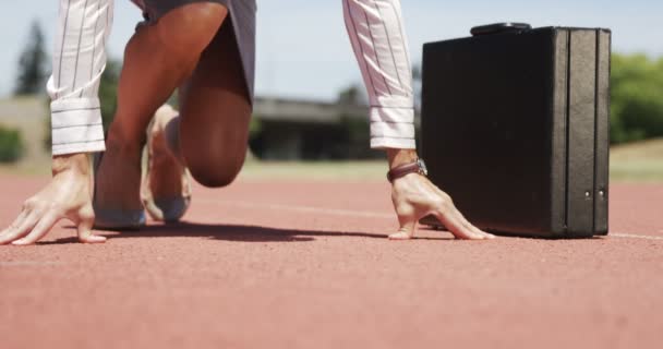 Businesswoman running on athletic ground — Stock Video