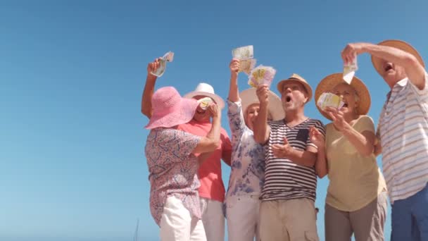 Ältere Menschen werfen mit Geldscheinen — Stockvideo