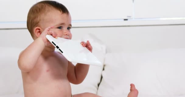 Cute baby chewing a tablet — Stock Video