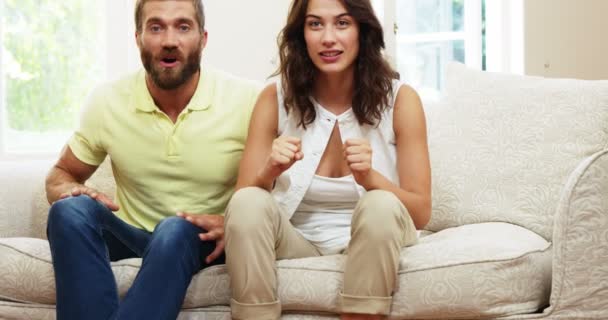 Couple getting excited in front of the tv — Stock Video