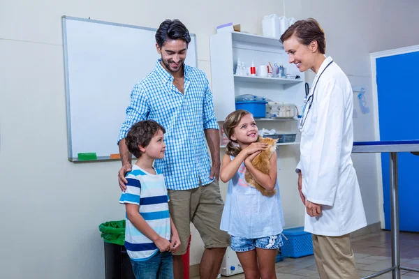 Familie lächelt mit Tierärztin — Stockfoto