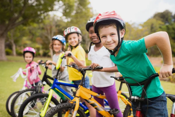 Children wearing helmet and posing on their bike — Stock Photo, Image