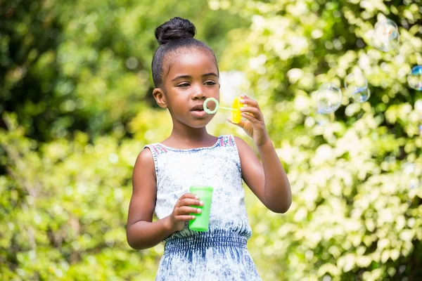 Little girl making bubble at park — Stock Photo, Image