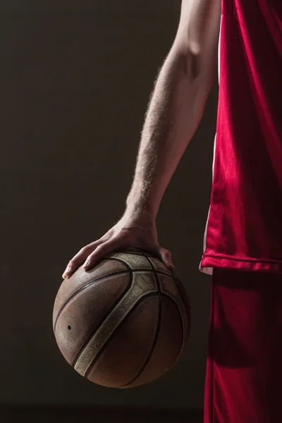 Close up on basketball held by basketball player — Stok Foto