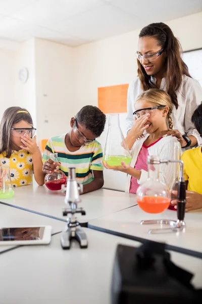 Un profesor observando a los alumnos haciendo ciencia —  Fotos de Stock