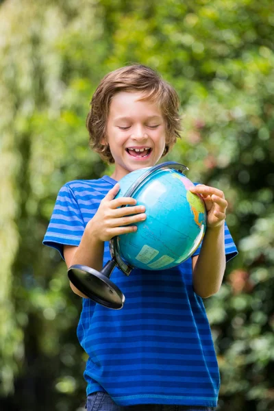 A little boy is holding a globe — Stock Photo, Image
