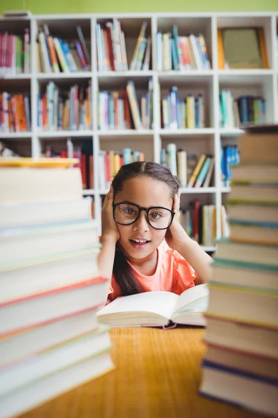 Girl sitting at a desk — Stock Photo, Image