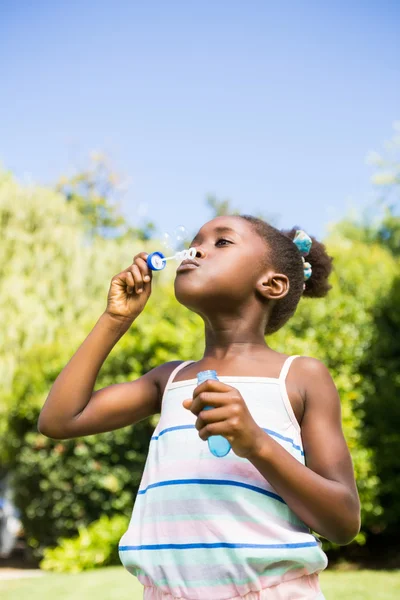 Roztomilá dívka smíšené rasy, usmívající se a hrát si s bublinami — Stock fotografie