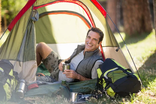 Man laying and holding cup — Stock Photo, Image