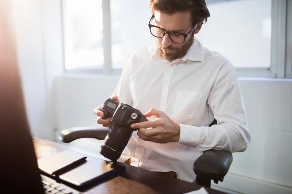 Businessman looking photos on his camera — Stock Photo, Image