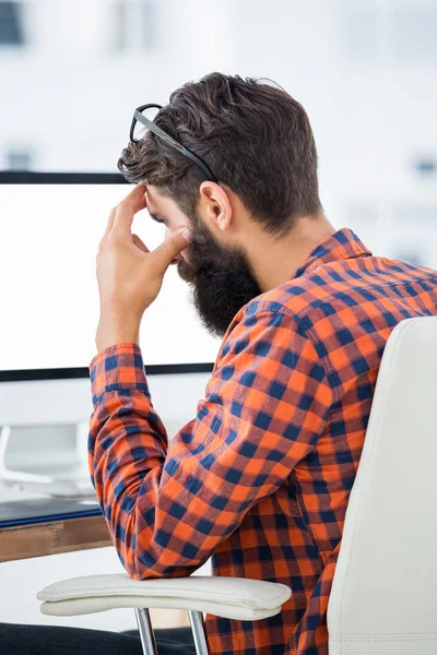 Hipster sitting in front of a computer — Stock Photo, Image
