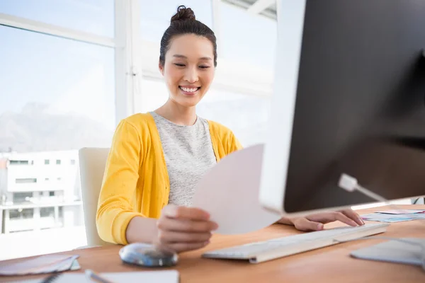 A businesswoman is working at her desk — 스톡 사진