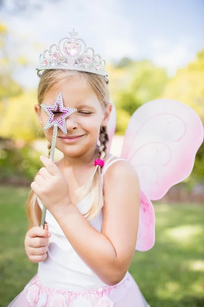 Portrait of cute girl with fairy dress looking across her magic — Stock Photo, Image