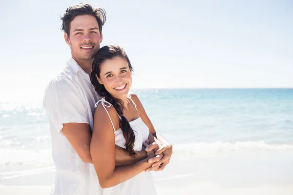 Casal feliz abraçando na praia — Fotografia de Stock